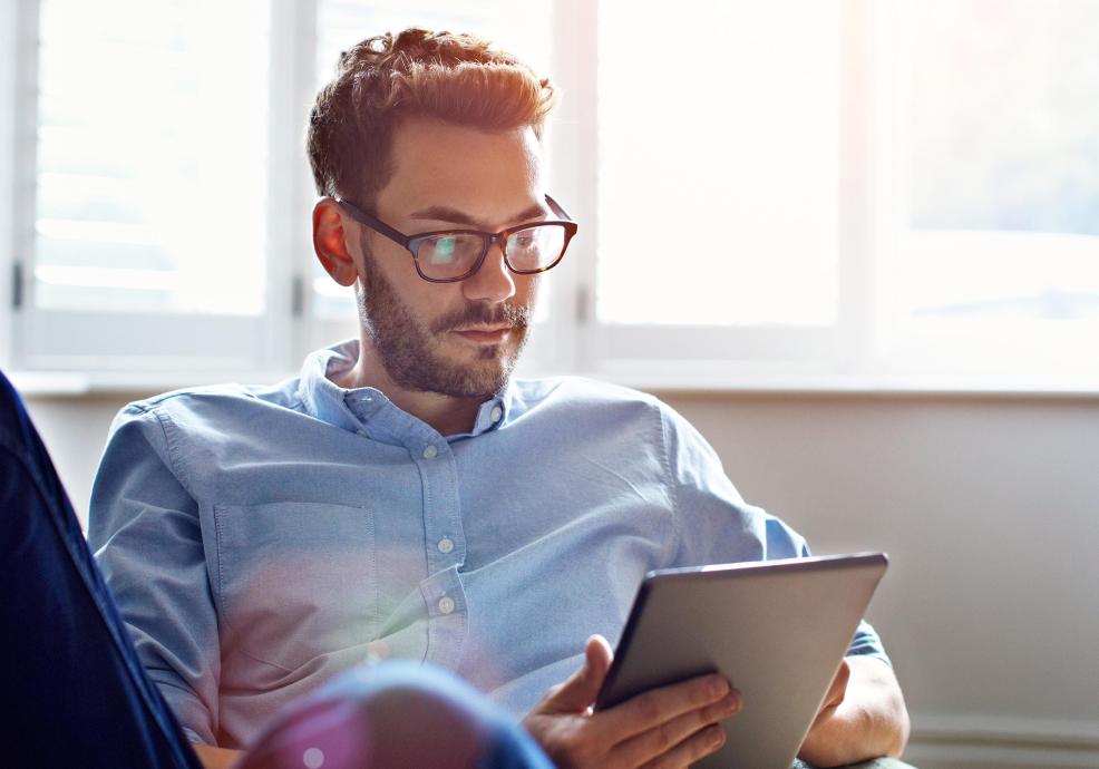 a businessman reading on his tablet