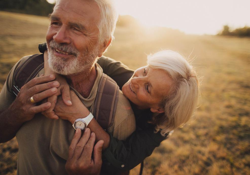 Elderly couple in a field.